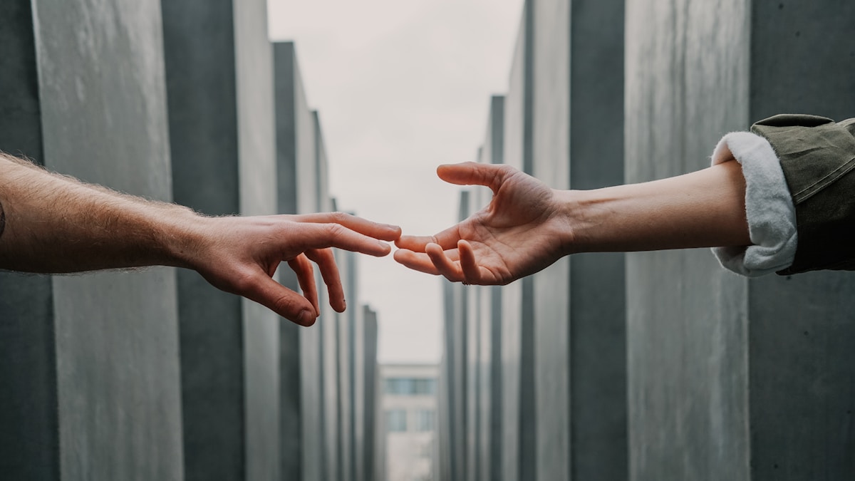 Two hands reaching toward each other — a visual metaphor for mental health support and connection